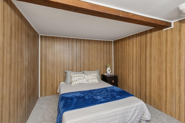 bedroom featuring carpet and wood walls