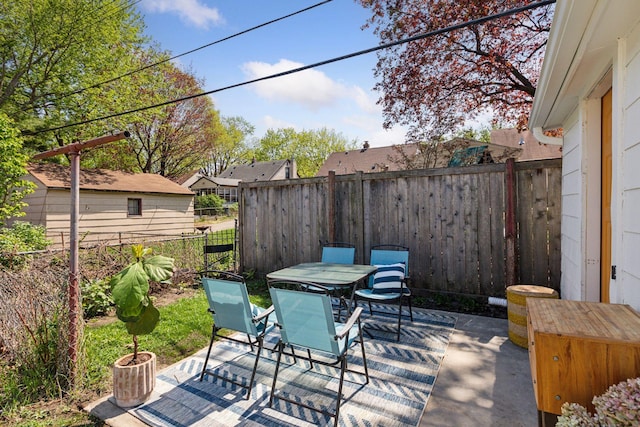 view of patio with outdoor dining space and a fenced backyard