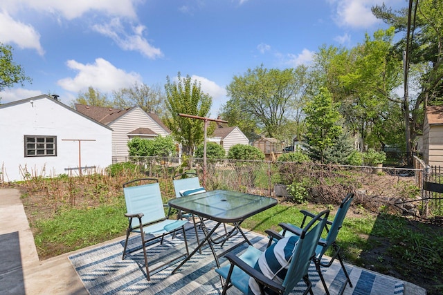 view of patio with fence and outdoor dining area