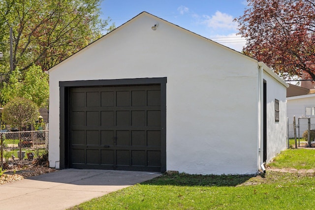 detached garage featuring fence