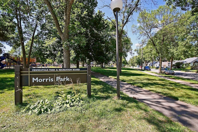 community sign featuring a lawn