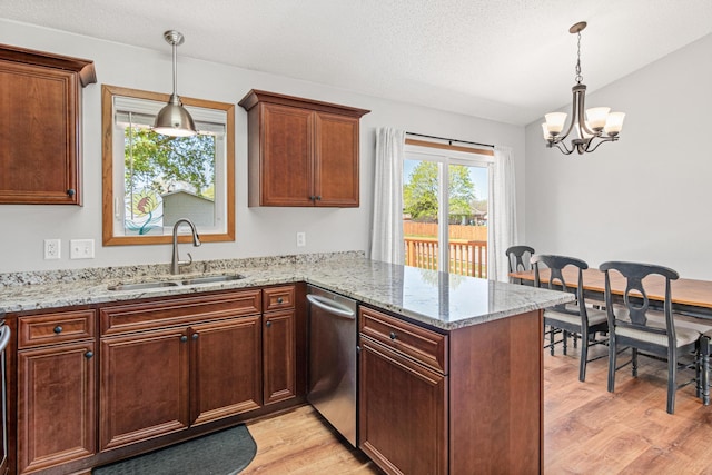 kitchen featuring a sink, dishwasher, a peninsula, light wood-style flooring, and a chandelier