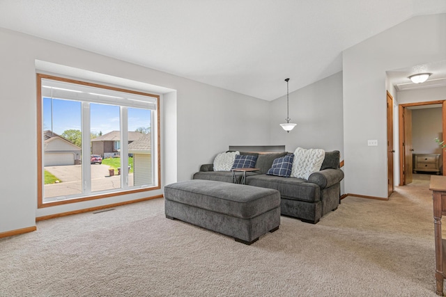 living room featuring light carpet, vaulted ceiling, and baseboards