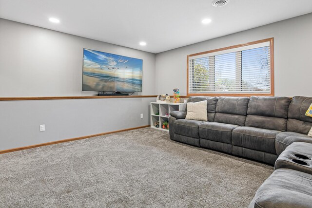 carpeted living area featuring recessed lighting and baseboards