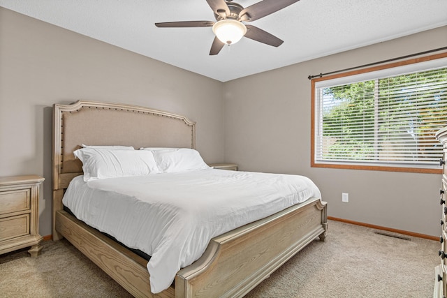 bedroom featuring carpet floors, baseboards, and ceiling fan
