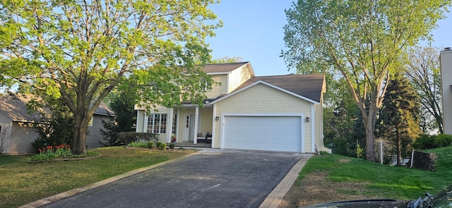 traditional-style home featuring driveway, a garage, and a front yard