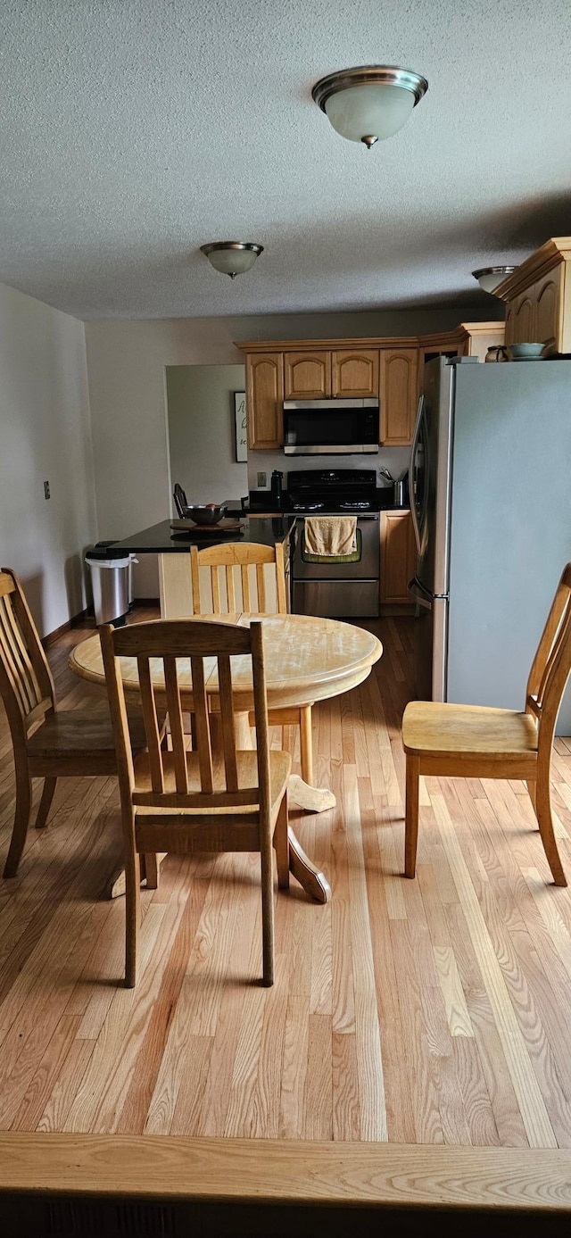14092 Dearborn Path, Rosemount, MN 55068 - dining space with wood finished floors and a textured ceiling