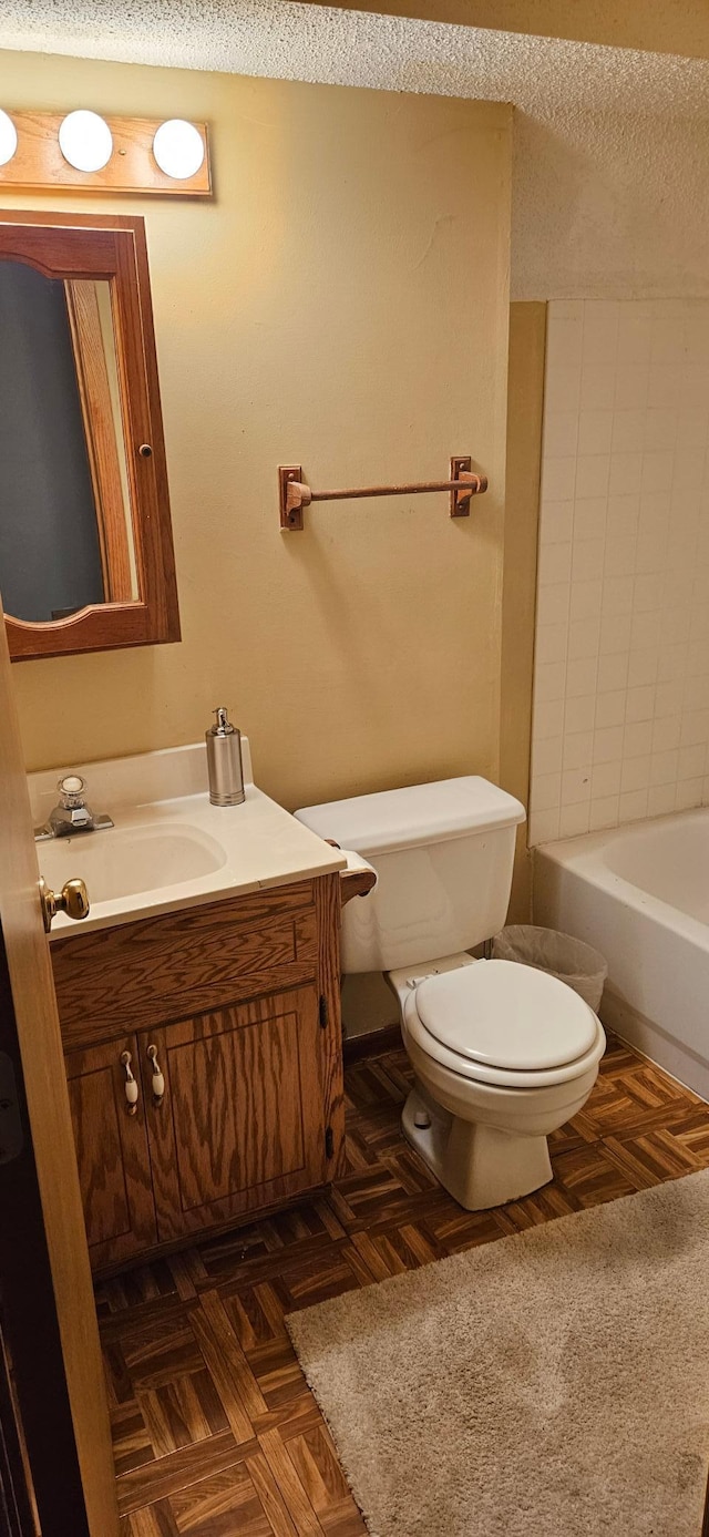 14092 Dearborn Path, Rosemount, MN 55068 - bathroom with vanity, toilet, and a textured ceiling