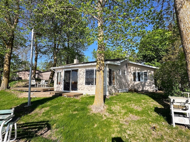 43084 335th Ave, Dora Twp, MN 56528 - view of front of property featuring a front lawn, a wooden deck, and a chimney