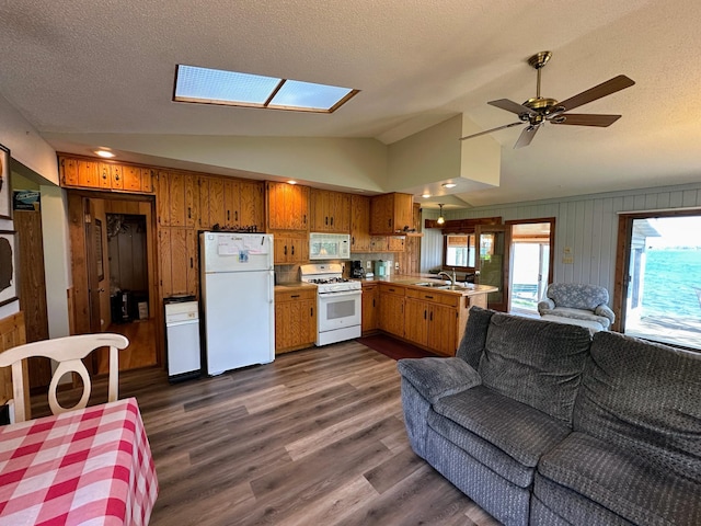 43084 335th Ave, Dora Twp, MN 56528 - kitchen featuring white appliances, open floor plan, lofted ceiling, brown cabinets, and a skylight
