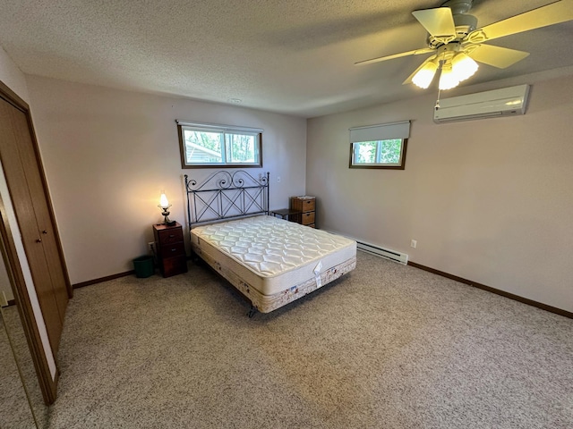 43084 335th Ave, Dora Twp, MN 56528 - carpeted bedroom featuring a wall mounted AC, multiple windows, ceiling fan, baseboards, and a textured ceiling