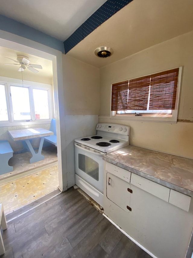 kitchen with white range with electric stovetop, white cabinets, dark wood finished floors, and a ceiling fan