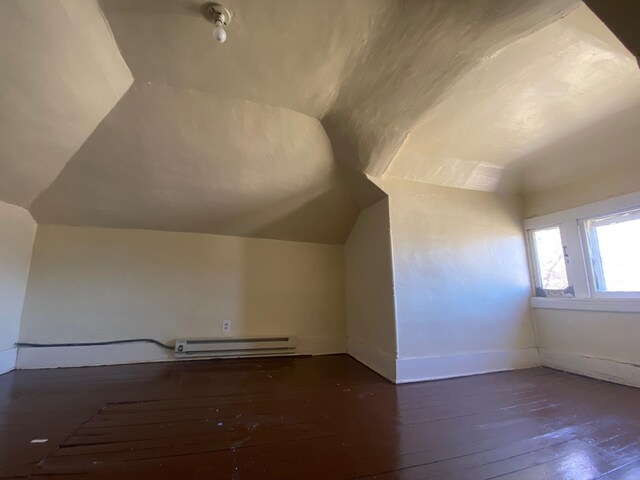 402 Main St, Mahnomen, MN 56557 - additional living space featuring baseboard heating, lofted ceiling, hardwood / wood-style floors, and baseboards