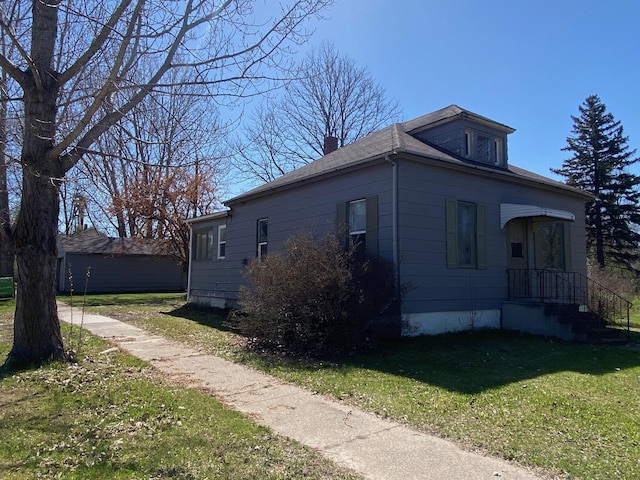 view of property exterior with a yard and a chimney