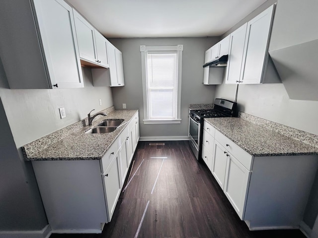 852 4th St E, Saint Paul, MN 55106 - kitchen with stainless steel gas range, a sink, under cabinet range hood, baseboards, and dark wood-style floors