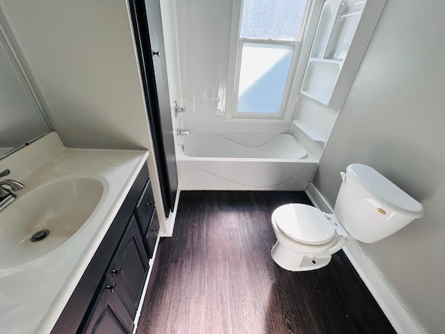 852 4th St E, Saint Paul, MN 55106 - bathroom with wood finished floors, vanity, toilet, shower / bathtub combination, and baseboards