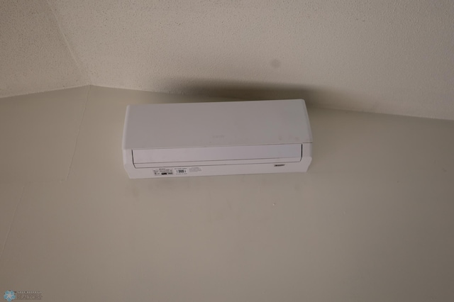 detailed view of a wall unit AC and a textured ceiling