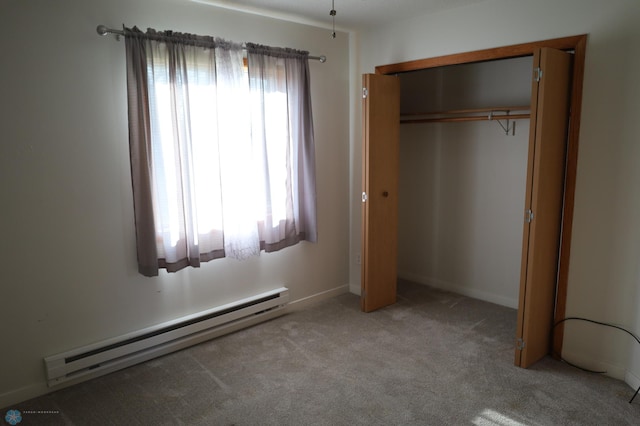 unfurnished bedroom featuring a baseboard heating unit, light colored carpet, and a closet