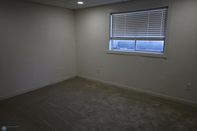 carpeted spare room featuring baseboards