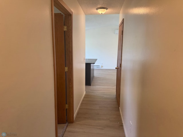 316 4th S, Breckenridge, MN 56520 - hallway featuring baseboards, light wood-style flooring, and a textured ceiling