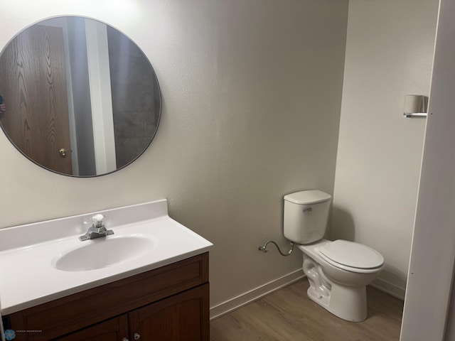 316 4th S, Breckenridge, MN 56520 - half bathroom with wood finished floors, vanity, toilet, and baseboards