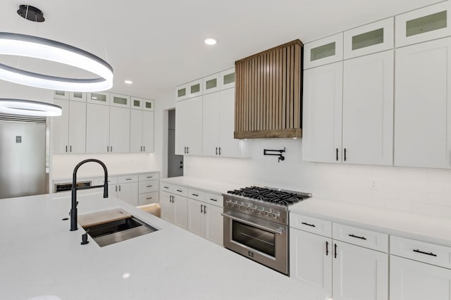 1796 Cobblestone Ct, Hastings, MN 55033 - kitchen featuring stainless steel stove, a sink, decorative backsplash, white cabinets, and recessed lighting
