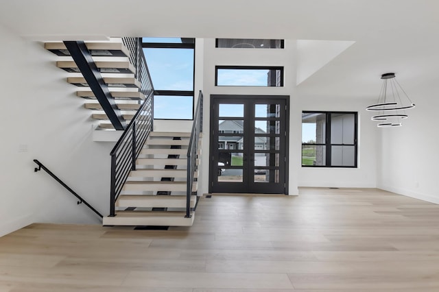 1796 Cobblestone Ct, Hastings, MN 55033 - entrance foyer featuring wood finished floors, stairway, a towering ceiling, and a chandelier