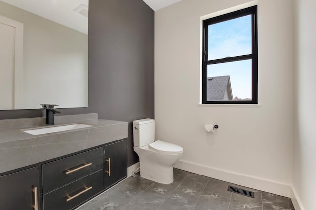 1796 Cobblestone Ct, Hastings, MN 55033 - bathroom with baseboards, toilet, and vanity