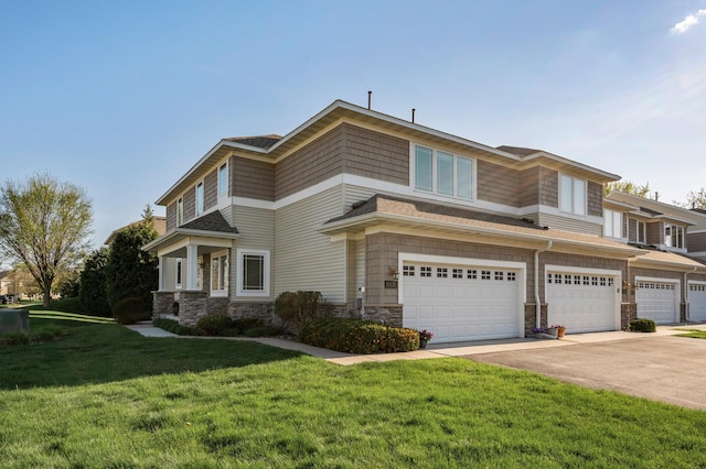 view of front of property with stone siding, concrete driveway, a front yard, and an attached garage