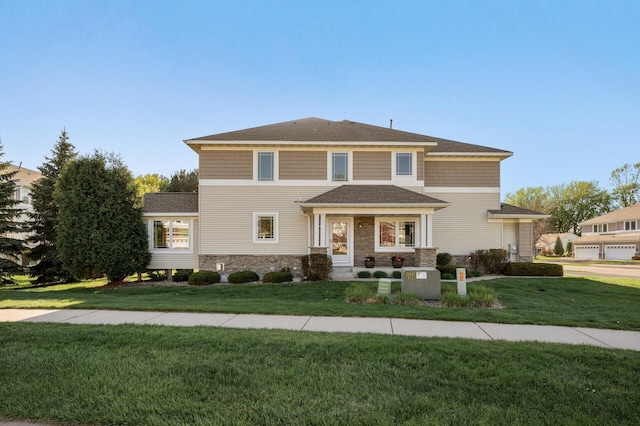 view of front of house with a front lawn, stone siding, and a shingled roof