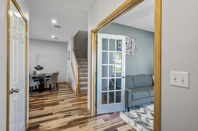 doorway featuring wood finished floors, stairs, recessed lighting, and french doors