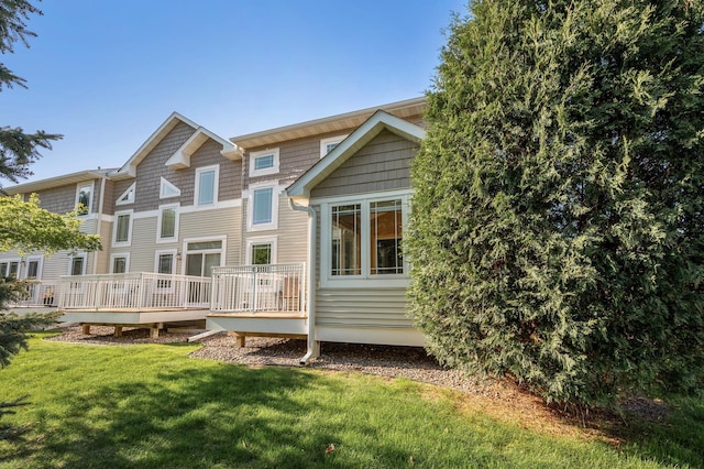back of house with a wooden deck and a yard