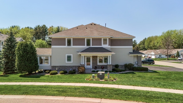 view of front of property with a front lawn and stone siding