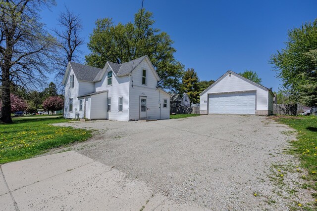 812 Main St, Dodge Center, MN 55927 - view of home's exterior with an outdoor structure, a garage, and a lawn