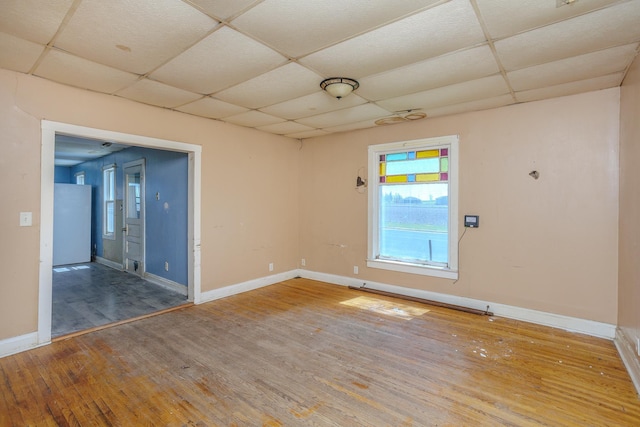 812 Main St, Dodge Center, MN 55927 - unfurnished room with a paneled ceiling, wood finished floors, and baseboards