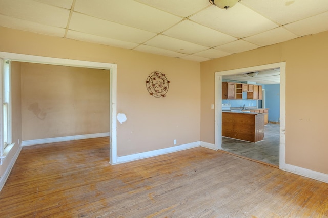 812 Main St, Dodge Center, MN 55927 - empty room featuring a drop ceiling, wood finished floors, baseboards, and a sink