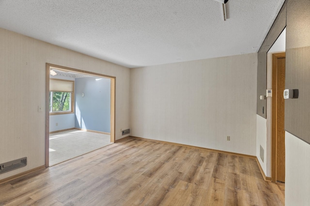 4348 Arden View Ct, Arden Hills, MN 55112 - unfurnished room with wood finished floors, a textured ceiling, and baseboards