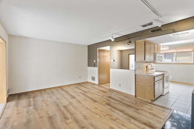 4348 Arden View Ct, Arden Hills, MN 55112 - kitchen with white appliances, track lighting, light countertops, light wood-style floors, and baseboards