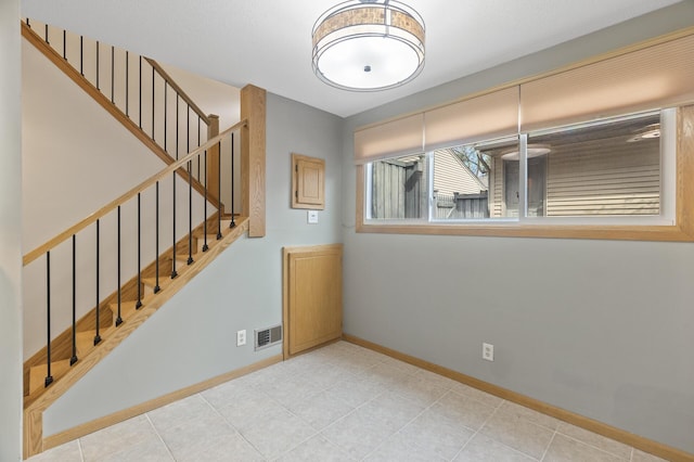 4348 Arden View Ct, Arden Hills, MN 55112 - empty room with baseboards, stairway, and light tile patterned floors