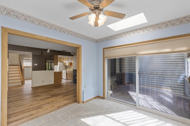 4348 Arden View Ct, Arden Hills, MN 55112 - unfurnished room with a skylight, rail lighting, a ceiling fan, stairway, and light tile patterned floors