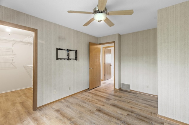4348 Arden View Ct, Arden Hills, MN 55112 - unfurnished room with wood finished floors, wallpapered walls, ceiling fan, and baseboards