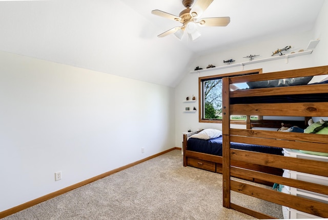 carpeted bedroom featuring lofted ceiling, baseboards, and ceiling fan