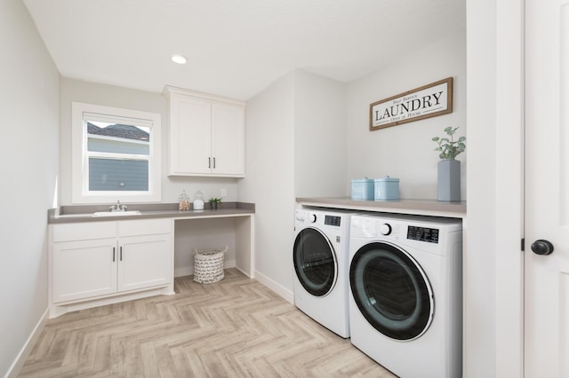 clothes washing area featuring independent washer and dryer, baseboards, cabinet space, and recessed lighting