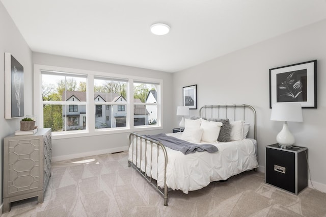 carpeted bedroom with baseboards