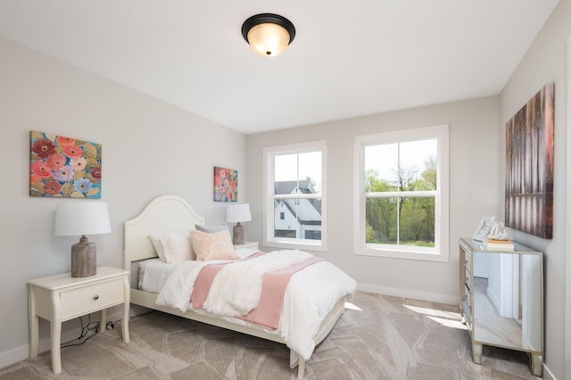 carpeted bedroom with baseboards