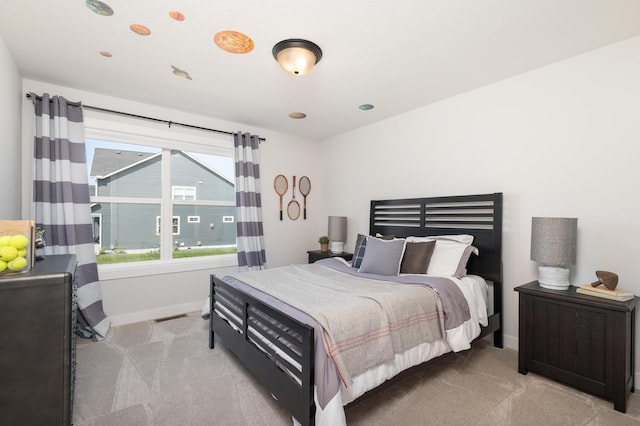 bedroom with carpet floors and baseboards