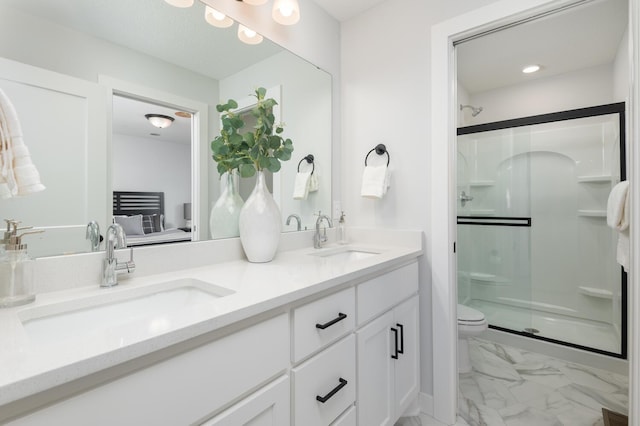 full bathroom with a stall shower, marble look tiles, double vanity, and toilet