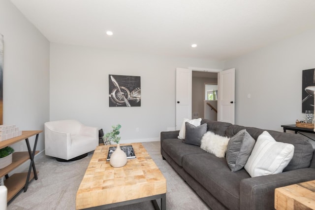 living room with light carpet and recessed lighting