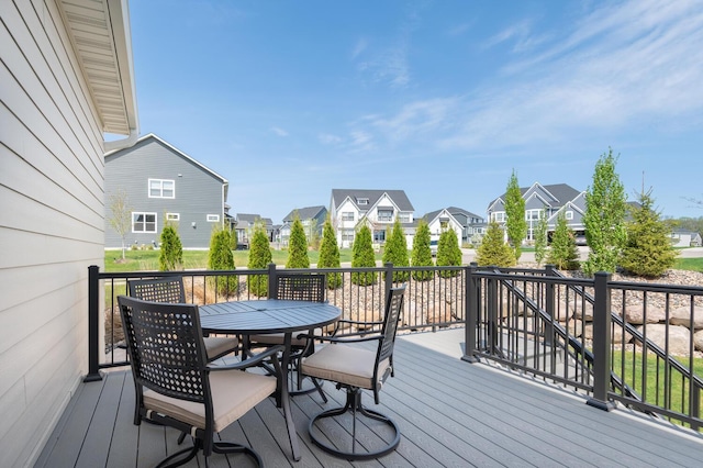 deck featuring a residential view and outdoor dining space
