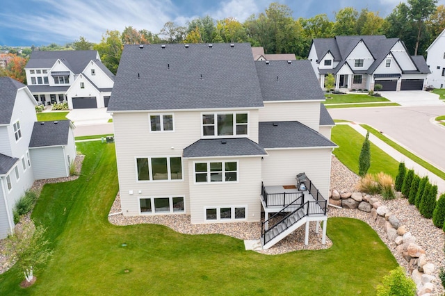 back of house with a residential view, stairway, a wooden deck, and a yard